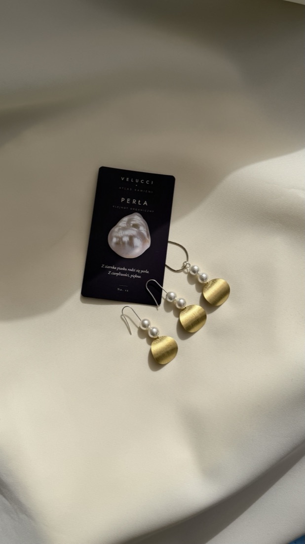 Selene pearl earrings placed on the pearl card